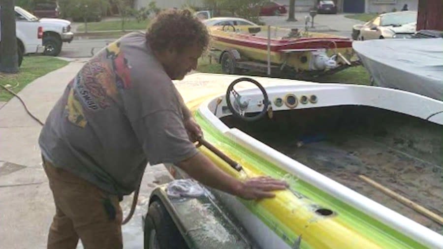Jonathan Mauk seen in a family photo working on his boat, one of his favorite hobbies.