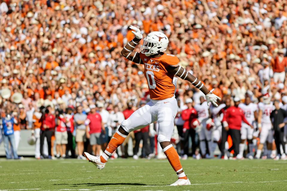 Texas linebacker DeMarvion Overshown celebrates a sack during the first quarter of the 2021 Red River rivalry game with Oklahoma at the Cotton Bowl. Overshown signed with Texas in 2018 as a highly regarded safety prospect from Arp but eventually was moved to linebacker.