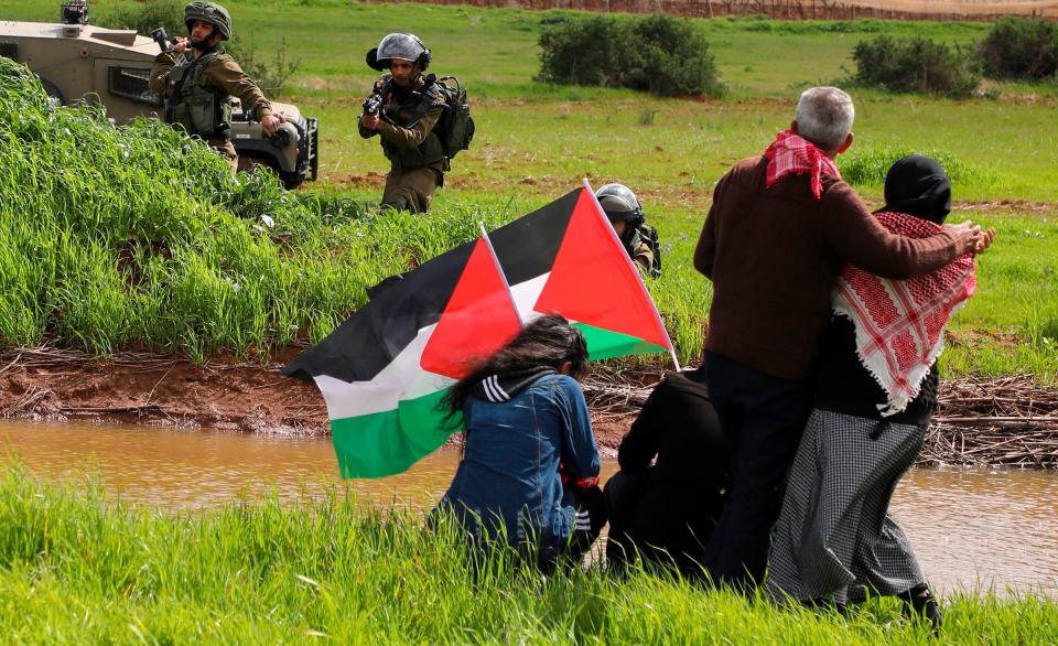 Israeli soldiers take aim as Palestinian demonstrators take part in a protest against the annexation of the Jordan Valley near the Jordan Valley on Feb. 29<span class="copyright">Jaafar Ashtiyeh—AFP/Getty Images</span>