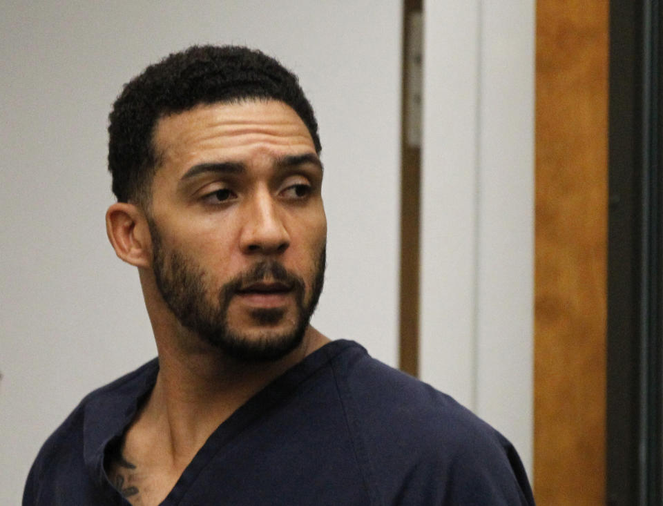 FILE - In this June 15, 2018, file photo, former NFL football player Kellen Winslow Jr., center, leaves his arraignment in Vista, Calif. Winslow, a former NFL No. 1 draft pick and son of a Hall of Famer who starred for his hometown San Diego Chargers, goes on trial Monday, May 20, 2019, on multiple charges including raping two women last year and raping an unconscious 17-year-old girl. He has pleaded not guilty to all charges.(Hayne Palmour/San Diego Union-Tribune via AP, Pool, File)