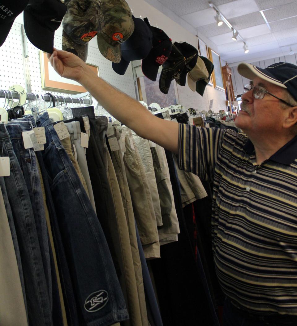 Monroe resident Jerry Samsel restocks hats at the Thrift Shop Association of Monroe. Currently, he is the only male member.
