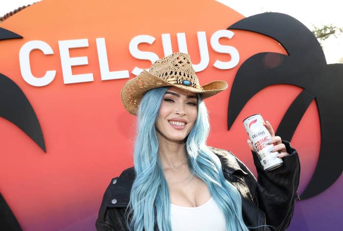 Closeup of Megan Fox holding a canned drink at an event