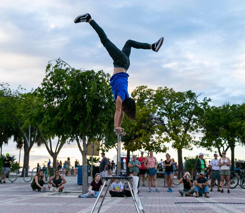 Street performer and comedy entertainer Jean Morabal, 29, performs tricks at Mallory Square in Key West, Florida on Sunday, December 12, 2021. MATIAS J. OCNER/mocner@miamiherald.com