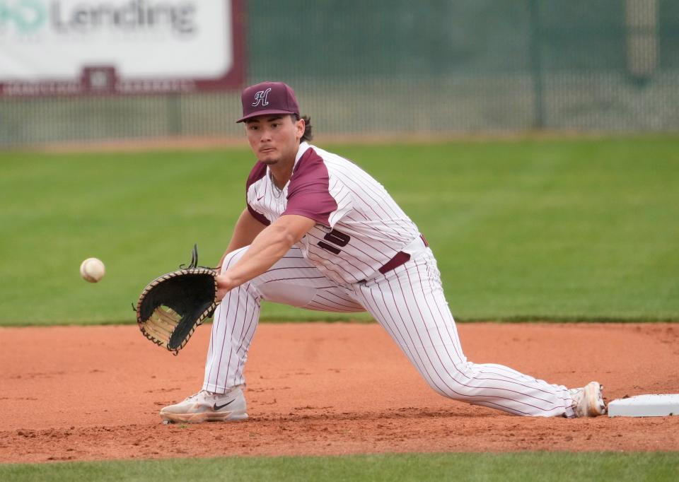 Hamilton first baseman Liam Wilson warms up before a game against Tolleson at Hamilton HS baseball field.