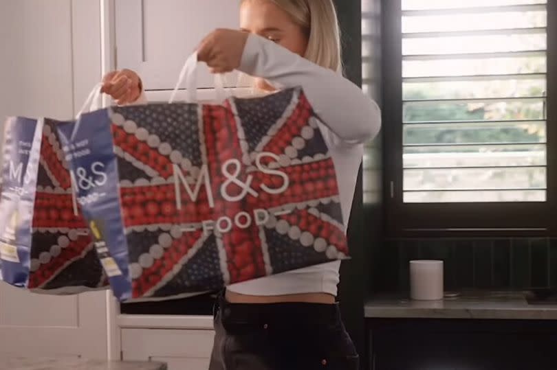 Molly-Mae showed off her M&S bags before she cooked up a roast dinner