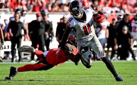 Tampa Bay Buccaneers cornerback M.J. Stewart (36) grabs the legs of Atlanta Falcons wide receiver Julio Jones (11) during the second half at Raymond James Stadium - Credit: USA TODAY