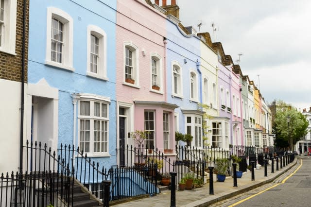 A colourful row of pastel painted Victorian townhouses in Chelsea, London.