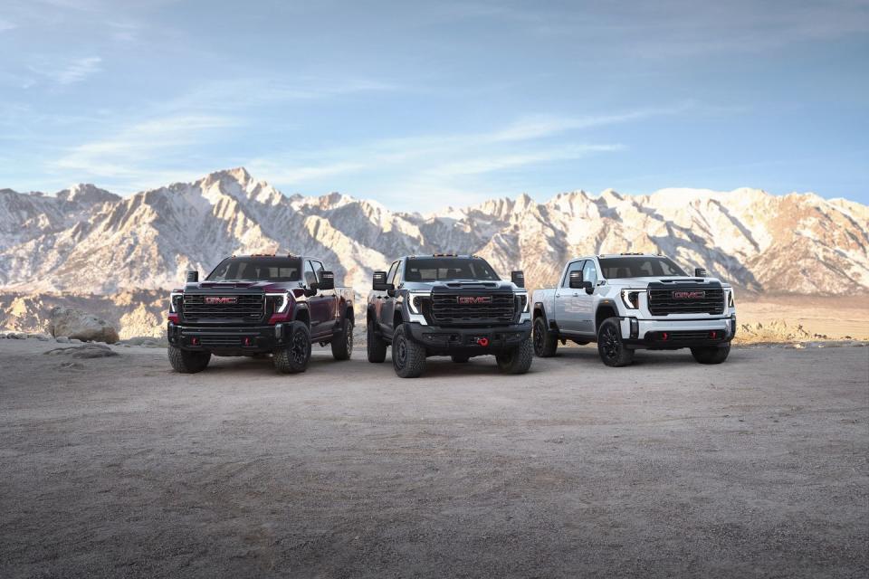 group shot of the 2024 gmc sierra 2500hd premium off road lineup from left to right sierra 2500hd at4x, sierra 2500hd at4x aev edition and sierra 2500hd at4