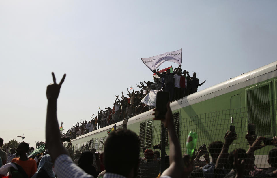Sudanese demonstrators arrive by train to participate in a demonstration, in Khartoum, Sudan, Thursday, Sept. 30, 2021. Thousands of Sudanese rallied in the capital of Khartoum against the country's military and demanding the formation of new transitional authorities that would exclusively consist of civilians. Thursday's demonstration accused the generals of derailing the country’s transition to democracy. (AP Photo/Marwan Ali)