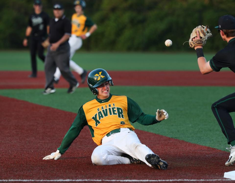 St. X’s Jack Thompson (8) beat the tag at third against Trinity’s Robert Morrow (7) at the St. X High School in Louisville, Ky. on April 27, 2022.   St. X won 8-2.