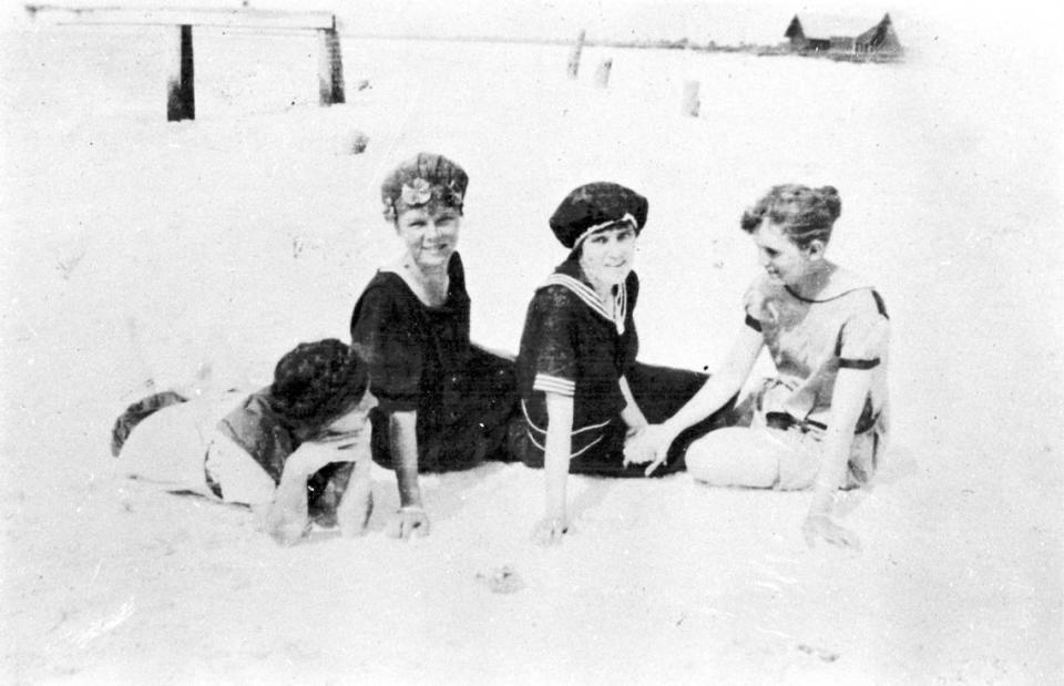 Four ladies pose on the beach in their bathing costumes at Anna Maria in 1917.