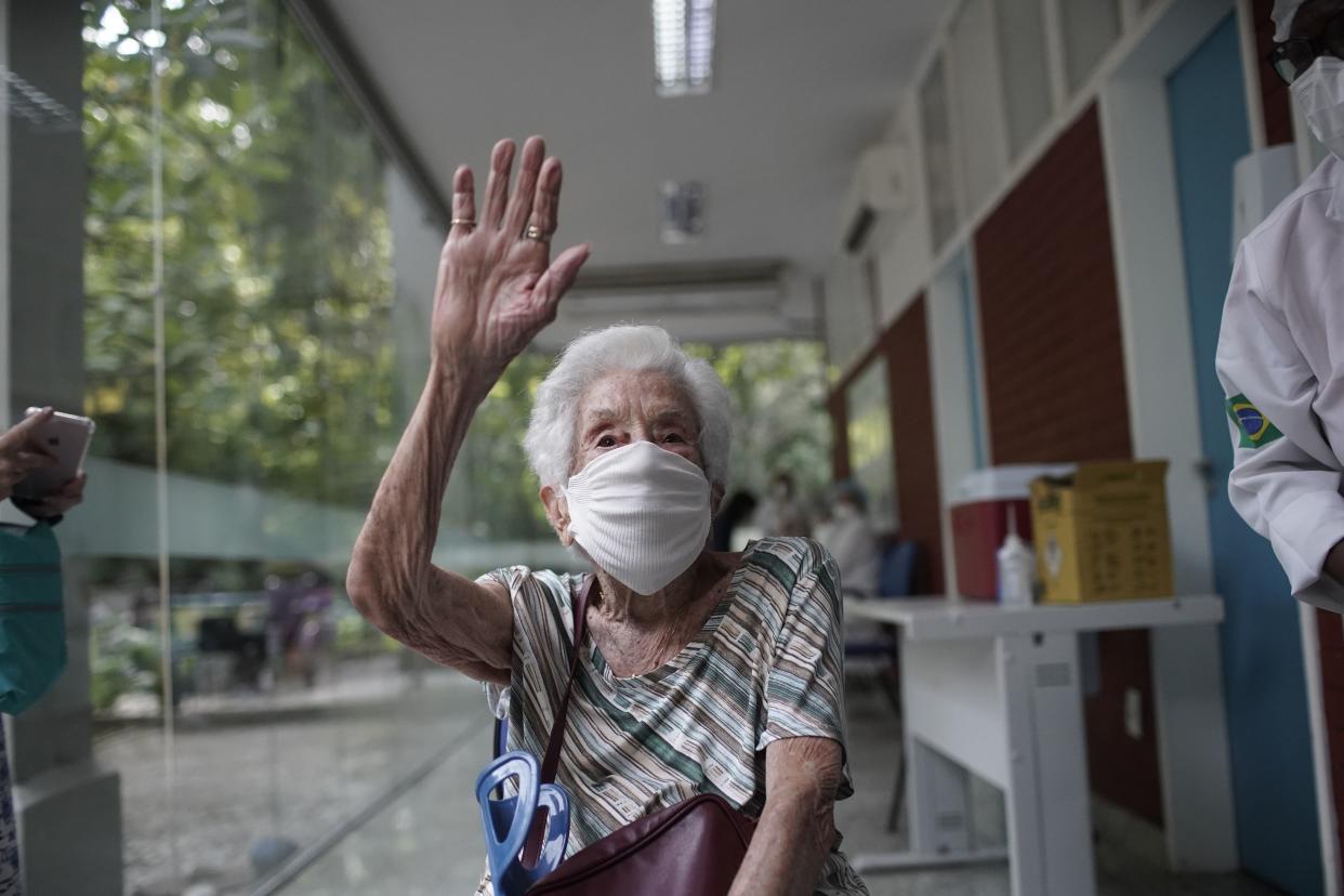 Joana de Oliveira, 100, celebrates after getting a shot of the Oxford-AstraZeneca vaccine for COVID-19 as part of a priority vaccination program for the elderly at a vaccination center in Rio de Janeiro, Brazil, Monday, Feb. 1, 2021.