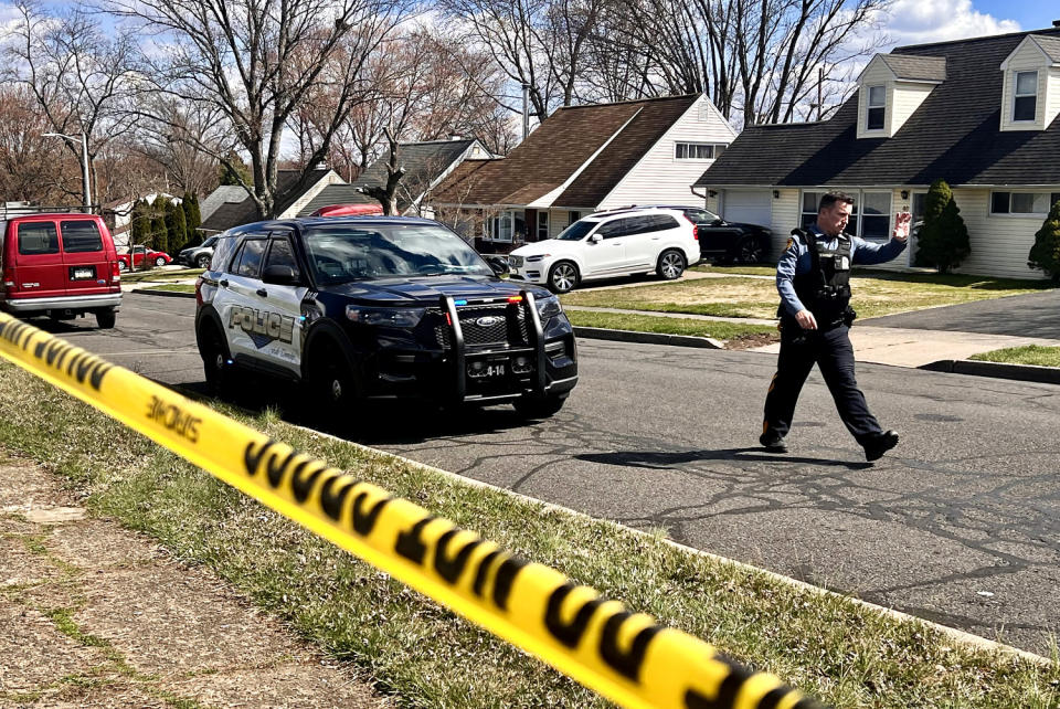 A police officer patrols a neighborhood  (Joe Lamberti / AFP - Getty Images)