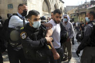 Israeli police detain a man during scuffles in the Old City of Jerusalem after Palestinians protested against French President Emmanuel Macron and the publication of caricatures of the Muslim Prophet Muhammad after Friday prayers at the Dome of the Rock Mosque on Oct. 30, 2020. (AP Photo/Mahmoud Illean)
