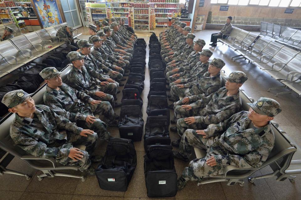 New recruits of China's People Liberation Army (PLA) soldiers sit at the waiting area of a railway station in Taiyuan, Shanxi province, September 10, 2013. (REUTERS/Stringer)