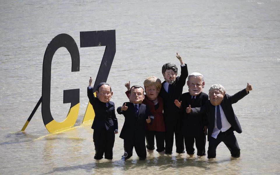 Protesters from Extinction Rebellion gather in Cornwall, during the G7 summit, on 13 June 2021 - Hollie Adams/Bloomberg