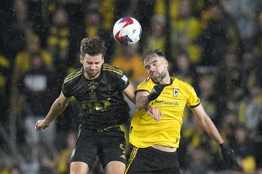 LAFC's Mario González and the Crew's Rudy Camacho leap up and try to head the ball