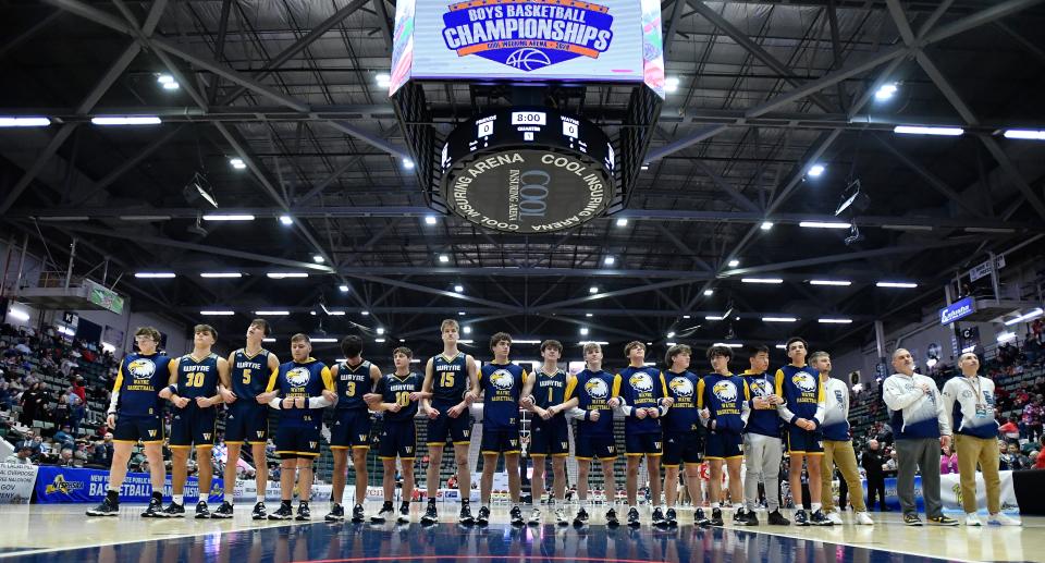 Wayne players and coaches stand for the national anthem before a NYSPHSAA Class A Boys Basketball Championships semifinal in Glens Falls, N.Y., Friday, March 15, 2024. Wayne advanced to the Class A final with a 61-48 win over Friends Academy-VIII.