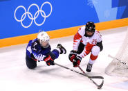 <p>Monique Lamoureux-Morando #7 of the United States fights for the puck with Emily Clark #26 of Canada in the third period during the Women’s Gold Medal Game on day thirteen of the PyeongChang 2018 Winter Olympic Games at Gangneung Hockey Centre on February 22, 2018 in Gangneung, South Korea. (Photo by Harry How/Getty Images) </p>