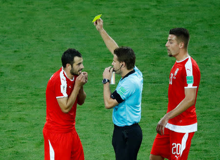 Soccer Football - World Cup - Group E - Serbia vs Switzerland - Kaliningrad Stadium, Kaliningrad, Russia - June 22, 2018 Serbia's Luka Milivojevic is shown a yellow card by referee Felix Brych REUTERS/Fabrizio Bensch