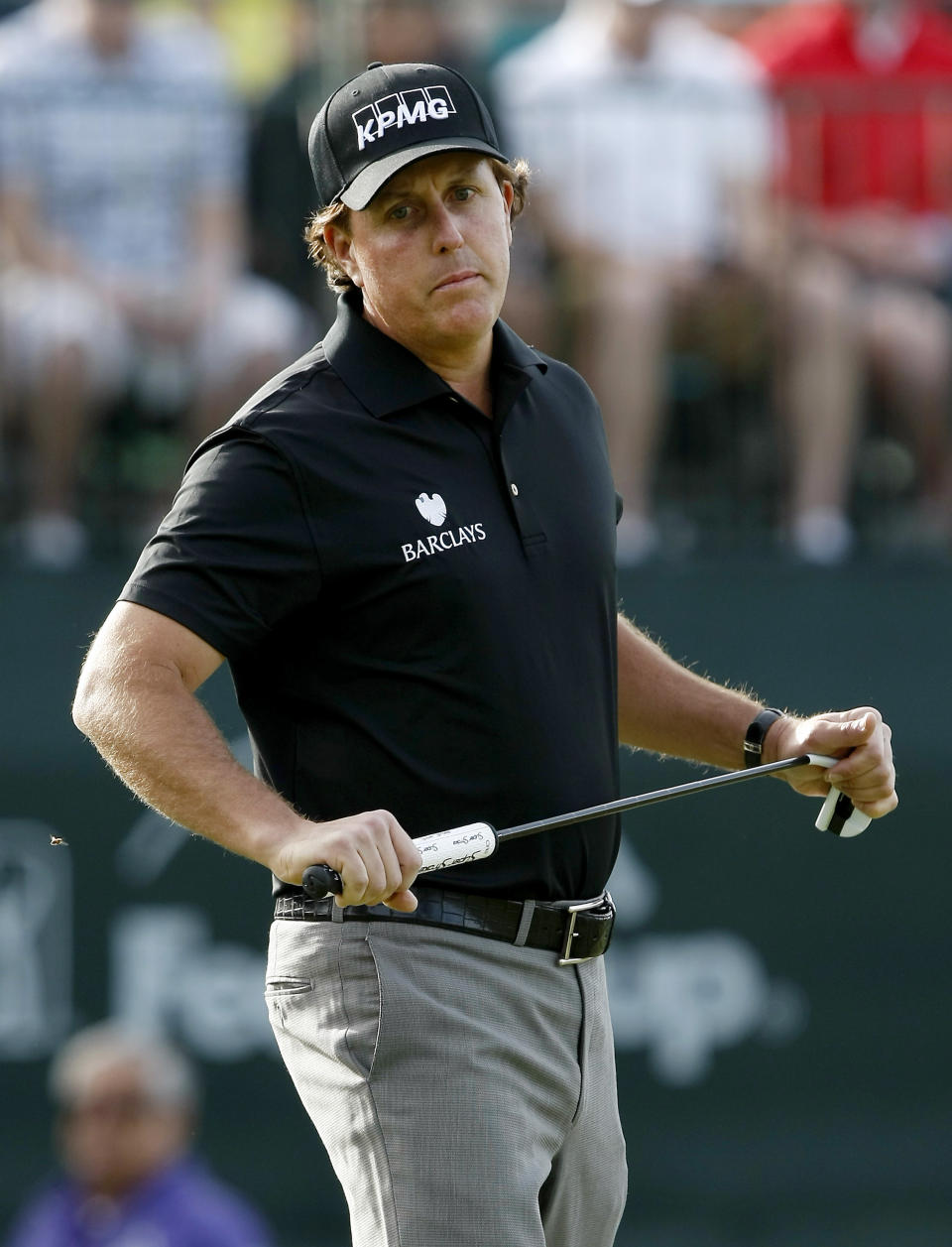 Phil Mickelson reacts to a missed putt on the 16th hole during the first round of the Waste Management Phoenix Open golf tournament on Thursday, Jan. 30, 2014, in Scottsdale, Ariz. (AP Photo/Rick Scuteri)