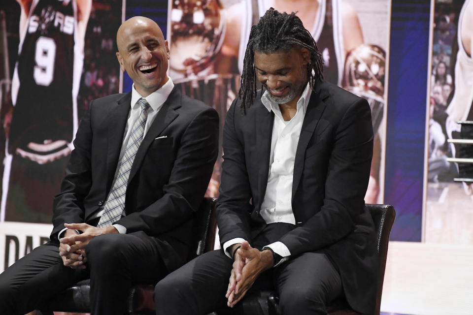 Presenters Manu Ginobili, left, and Tim Duncan laugh as Tony Parker speaks during his enshrinement at the Basketball Hall of Fame, Saturday, Aug. 12, 2023, in Springfield, Mass. (AP Photo/Jessica Hill)