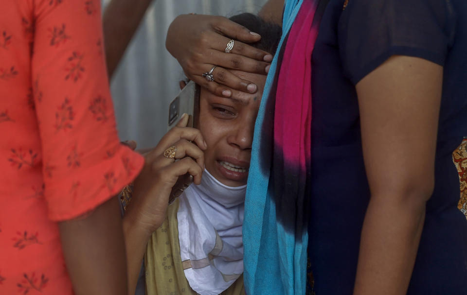 Relatives of a person who died of COVID-19 mourn outside a field hospital in Mumbai, India, Monday, May. 3, 2021..(AP Photo/Rafiq Maqbool)