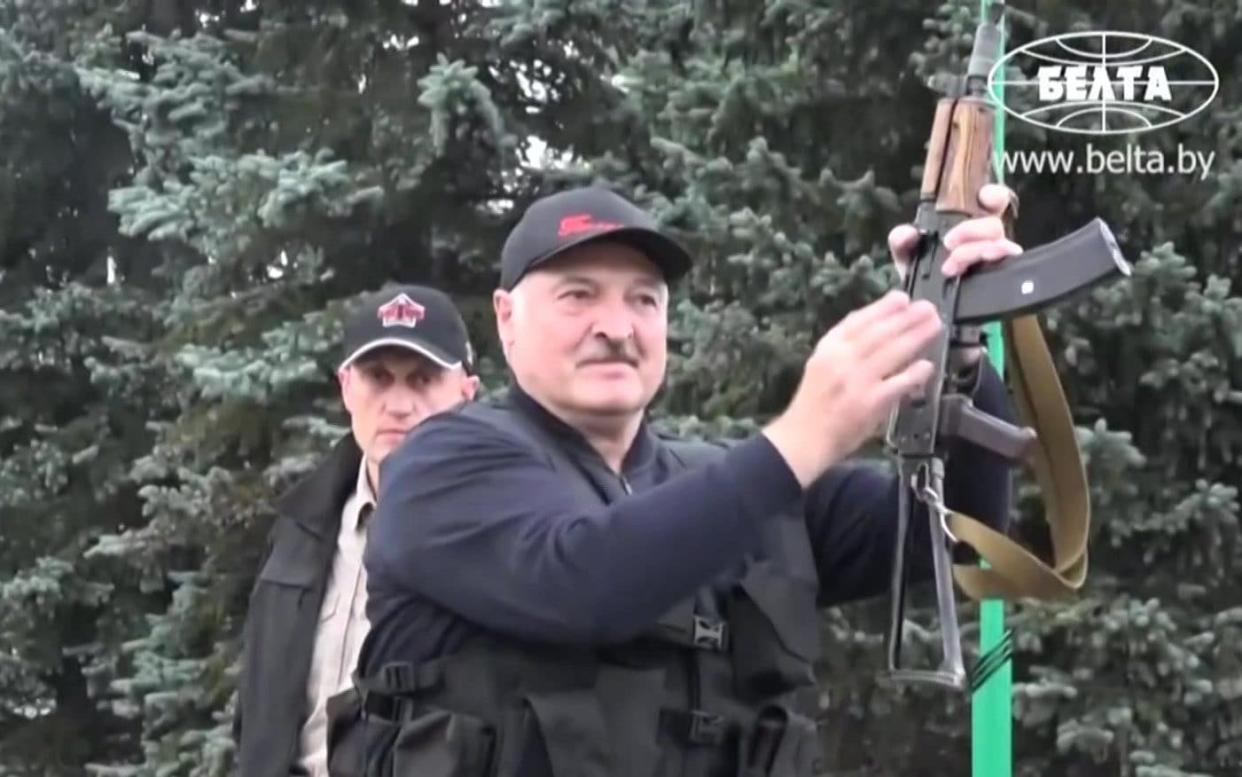 State video showed an armour-clad President Alexander Lukashenko holding an automatic rifle as he arrived at his residence in Minsk  - GETTY IMAGES