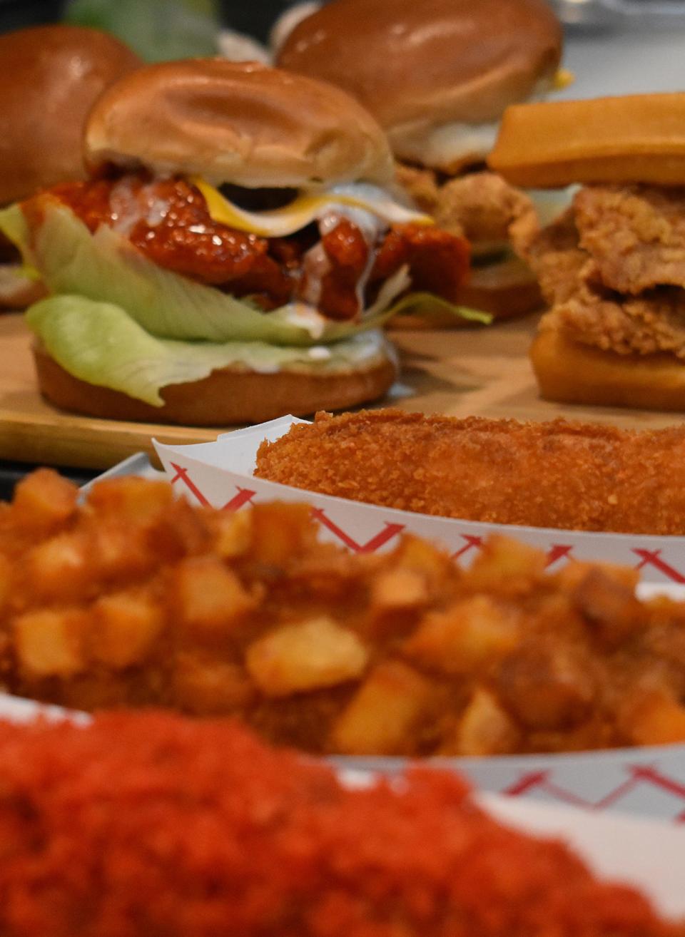 A spread of Korean corn dogs and Korean fried chicken sandwiches is displayed at Chicken Story in Fall River on Wednesday Nov. 22, 2023.