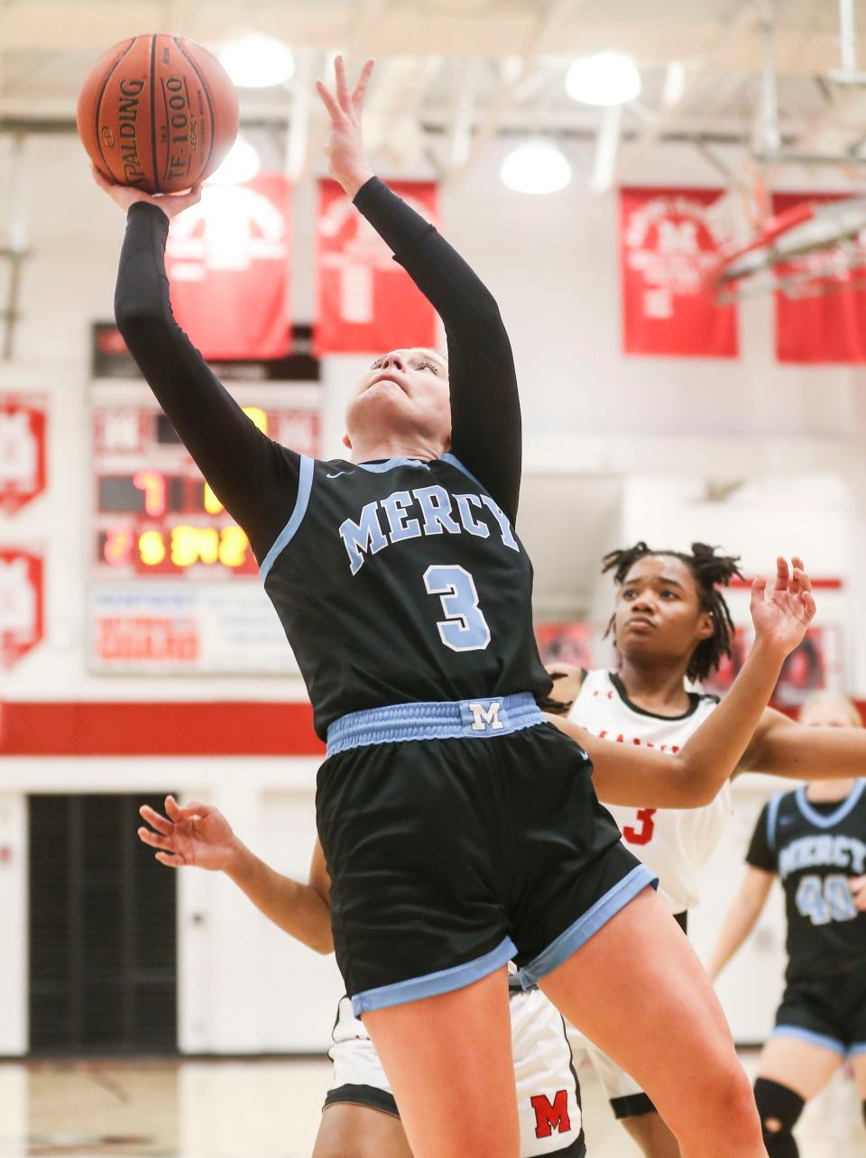 Mercy's Mary Smith goes for two against DuPont Manual Tuesday night at DuPont Manual High School. Dec. 6, 2022