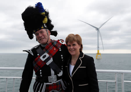 Scotland's first Minister Nicola Sturgeon stands with piper Norman Fiddes at the inauguration of the European Offshore Wind Deployment Centre (EOWDC) off Aberdeen, Scotland, Britain Sep 7, 2018. REUTERS/Russell Cheyne