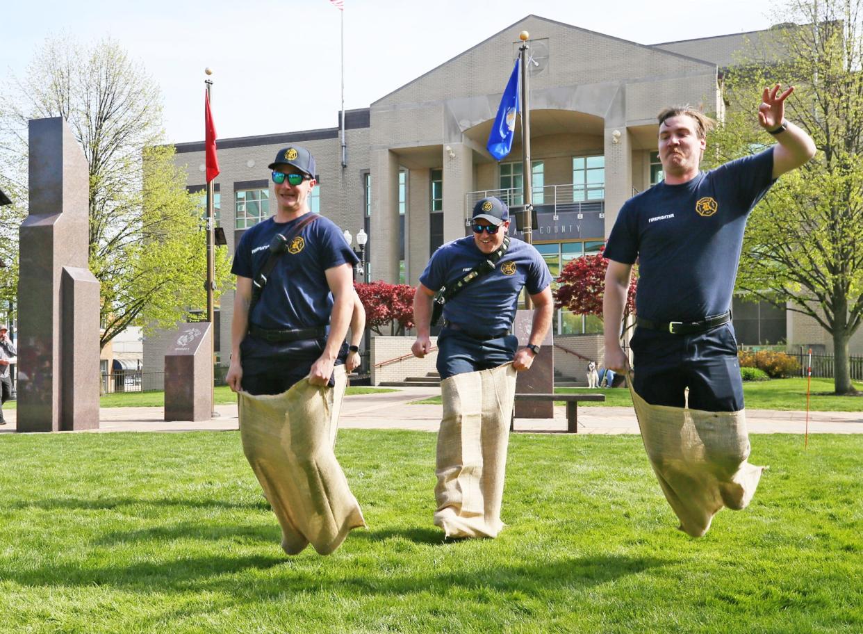 Ravenna fire/medics, from left, Grant Semaca, Jesse Zivoder and Sean Bryant are the first to compete in the potato sack race during the Ravenna Jo-Jo Fest Friday.
