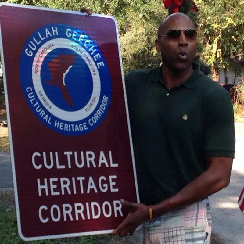 Derek Hankerson, who has Gullah Geechee heritage, stands beside a sign marking the Gullah Geechee Heritage Corridor which spands along the eastern coast of North Carolina to St. Augustine. The corridor was approved May 15, 2013.