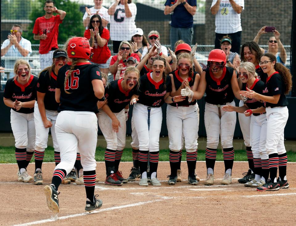 Jaelynn Nelson is met by teammates after hitting a solo homer during a 12-0 win against Portsmouth in a Division III district final at Unioto High School in Chillicothe. Nelson shared MVL Small School Division player of the year accolades with New Lexington's Jayden Allen.