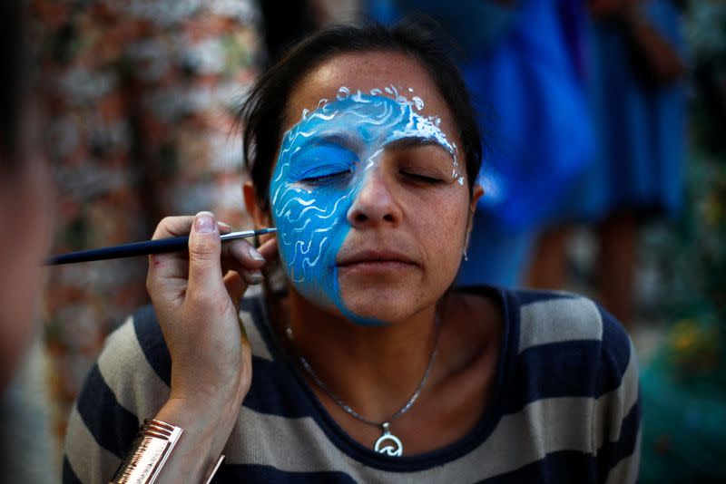 An activist prepares to take part in the 'Blue Climate March' outside the UN Ocean Conference in Lisbon to urge world leaders to act and protect the environment, in Lisbon