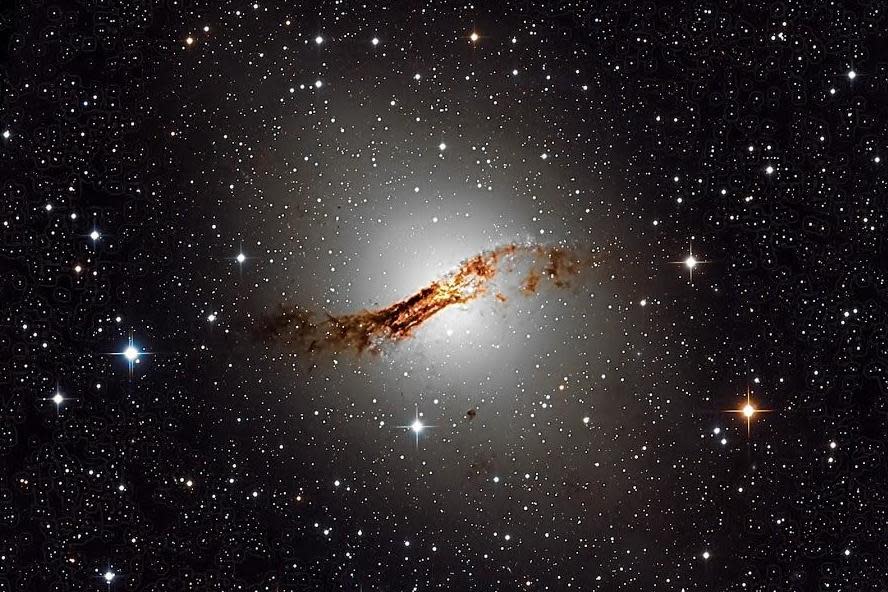 Centaurus A, an edge-on galaxy, has a super-massive black hole at its centre equivalent to 50 million suns. This image was captured by UCL students using a remote telescope in Chile (UCL Observatory)