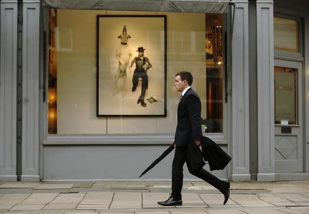 A man passes a gallery in London March 25, 2014. REUTERS/Luke MacGregor