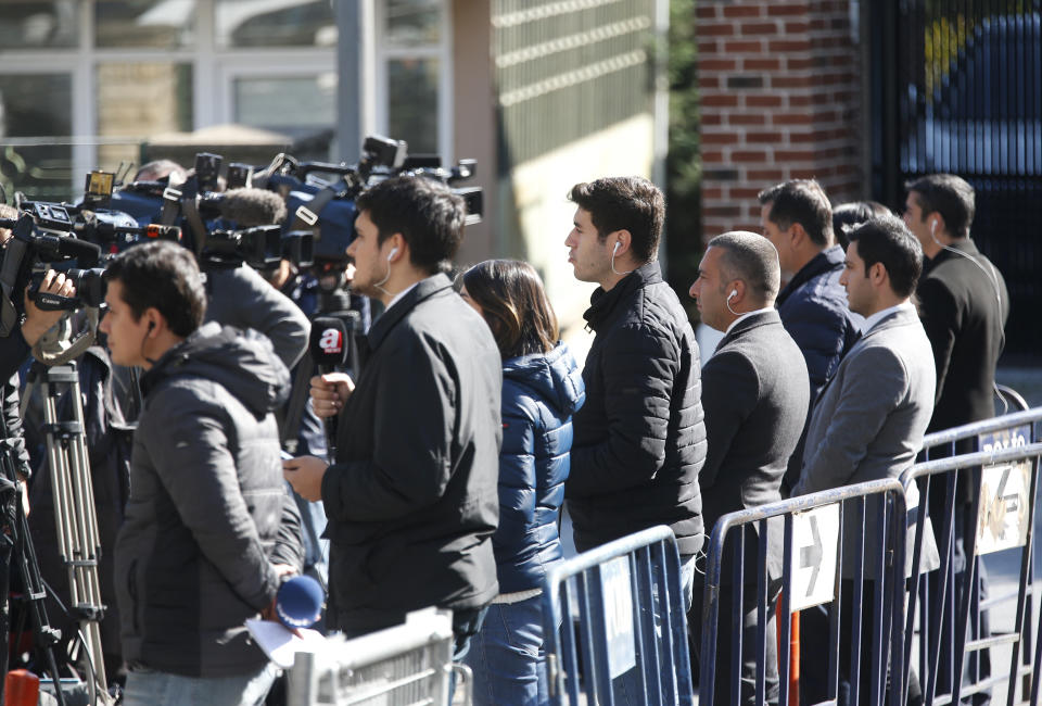 Members of the media report near Saudi Arabia's consulate, Friday, Oct. 26, 2018. The Saudi officials who killed journalist Jamal Khashoggi in their Istanbul consulate must reveal the location of his body, Turkey's President Recep Tayyip Erdogan said Friday in remarks that were sharply critical of the kingdom's handling of the case.(AP Photo/Lefteris Pitarakis)