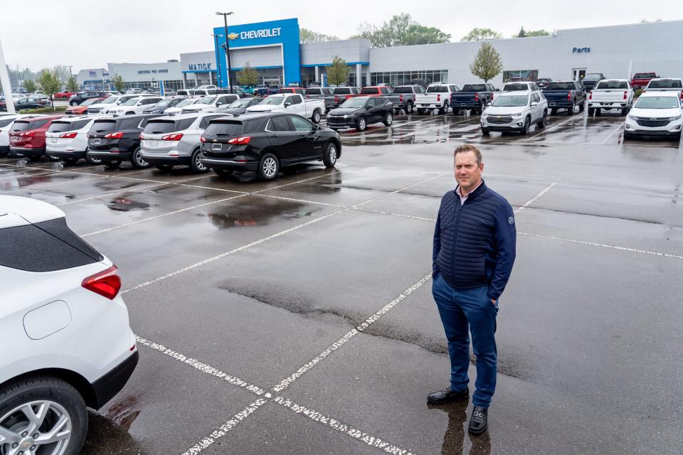 Matick Chevrolet Vice President and Owner Paul Zimmermann stands in an empty row amongst other spaces where new vehicles would be parked in a lot at Matick Chevrolet in Redford on Monday, May 3, 2021.