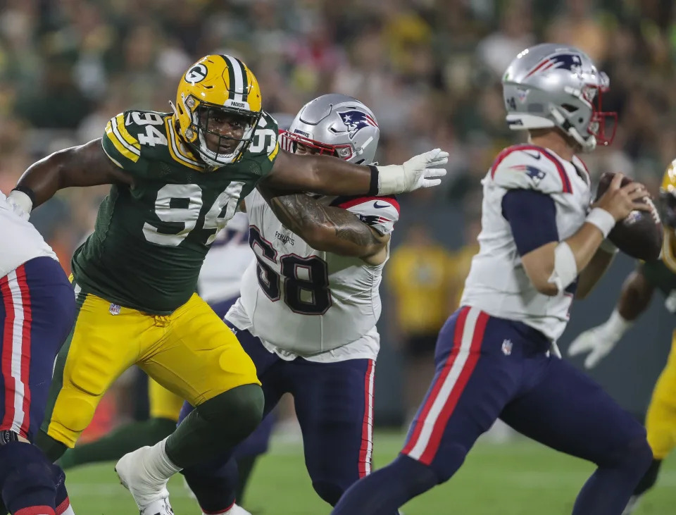 Aug 19, 2023; Green Bay, WI, USA; Green Bay Packers defensive end Karl Brooks (94) rushes <a class="link " href="https://sports.yahoo.com/nfl/teams/new-england/" data-i13n="sec:content-canvas;subsec:anchor_text;elm:context_link" data-ylk="slk:New England Patriots;sec:content-canvas;subsec:anchor_text;elm:context_link;itc:0"&gtNew England Patriots</a> quarterback <a class="link " href="https://sports.yahoo.com/nfl/players/33403" data-i13n="sec:content-canvas;subsec:anchor_text;elm:context_link" data-ylk="slk:Mac Jones;sec:content-canvas;subsec:anchor_text;elm:context_link;itc:0"&gtMac Jones</a> (10) during their preseason football game at Lambeau Field. Mandatory Credit: Tork Mason-USA TODAY Sports