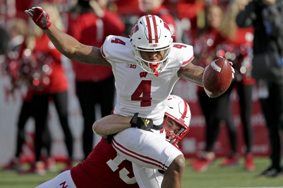 Wisconsin wide receiver A.J. Taylor (4) extends the ball over the goal line for a touchdown against Nebraska safety Marquel Dismuke (19) during the first half of an NCAA college football game in Lincoln, Neb., Saturday, Nov. 16, 2019. (AP Photo/Nati Harnik)