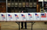 A man votes in Loudon, New Hampshire