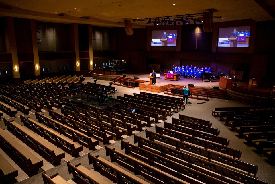 Rev. Roger Grimmett delivers his message to an empty sanctuary and a camera crew for First United Methodist Church's Sunday morning service in Springfield, Illinois.