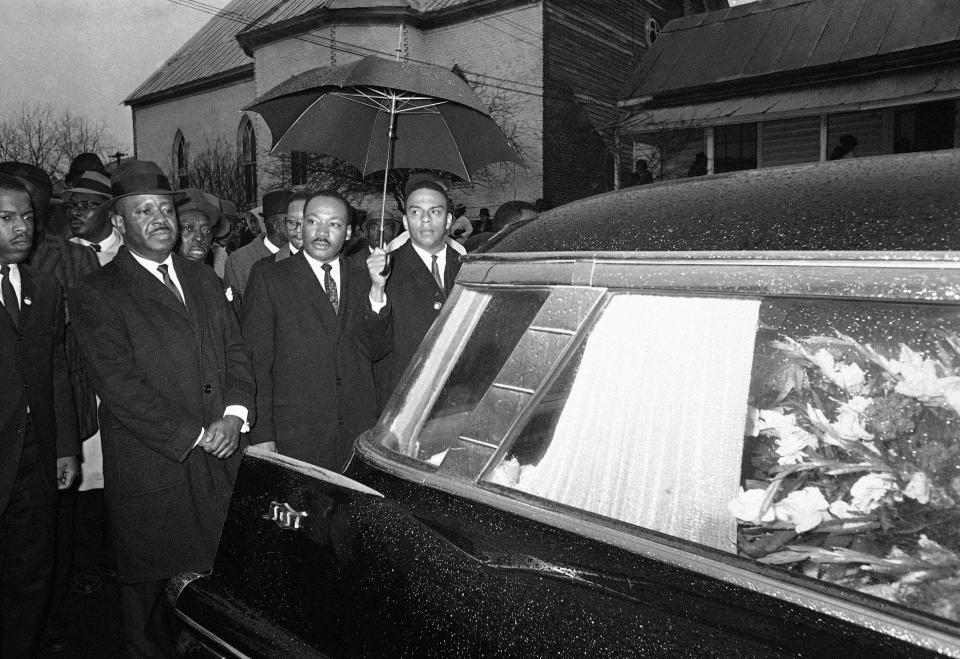 FILE - In this March 1, 1965, photo, the Rev. Martin Luther King Jr. leads a procession behind the casket of Jimmie Lee Jackson during funeral rites at Marion, Ala. From left, John Lewis, the Rev. Ralph Abernathy, King and the Rev. Andrew Young. In 1965, Jackson was fatally shot at a protest in Marion. It was that killing that sent hundreds of people to Selma for a march at the Edmund Pettus Bridge two weeks later. (AP Photo/File)