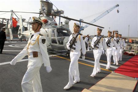 Chinese sailors march in formation on the helipad of the Chinese frigate Yancheng docked at Limassol port, January 4, 2014. REUTERS/Andreas Manolis