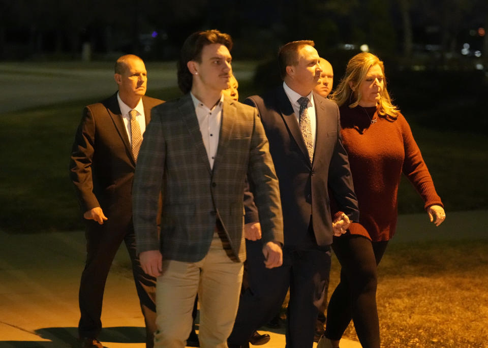 Paramedics Jeremy Cooper, third from right, and Peter Cichuniec, back left, enter the Adams County, Colo., Justice Center, Friday, Dec. 22, 2023, in Brighton, Colo. The two paramedics were convicted Friday in the 2019 killing of Elijah McClain, who they injected with an overdose of the sedative ketamine after police put him in a neck hold. (AP Photo/David Zalubowski)