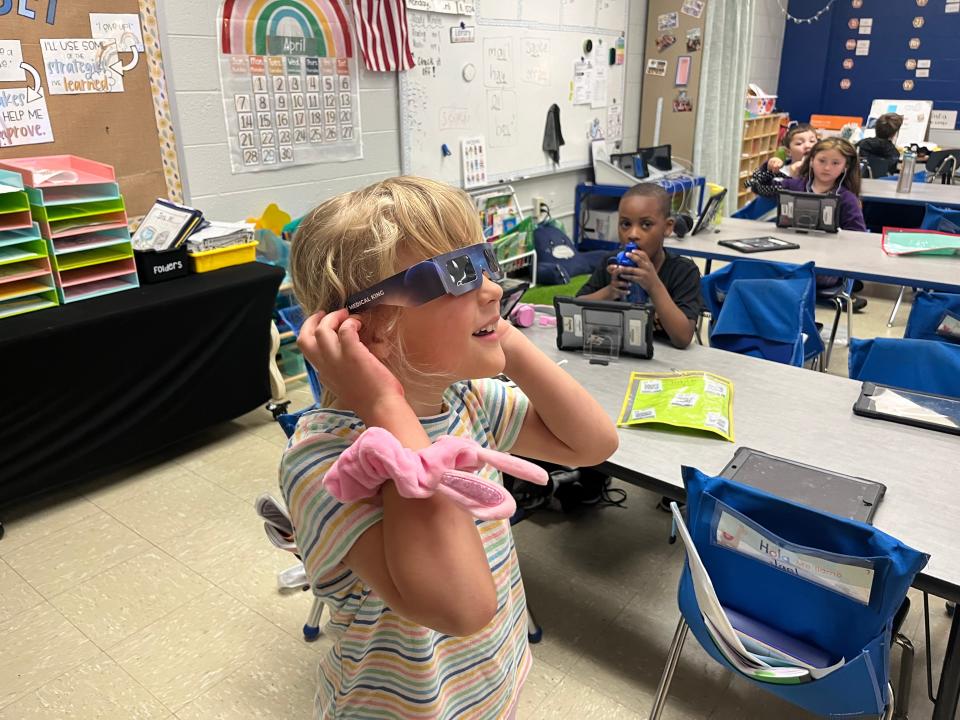 Lucy Collins, 6, tries on her glasses for the first time before going outside to see the eclipse on the lawn at Riverside Elementary School on April 8, 2024 in Columbia, Tenn.