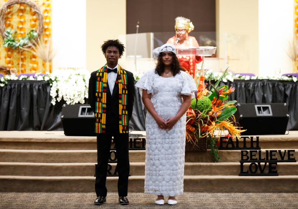 Gwen Marshall stands at the podium behind Jaela Maikal Burris and her escort Stephon Fewell Hawthorne during the 8th annual Ariya celebration at Deliverance Temple Ministries on Friday, June 17, 2022