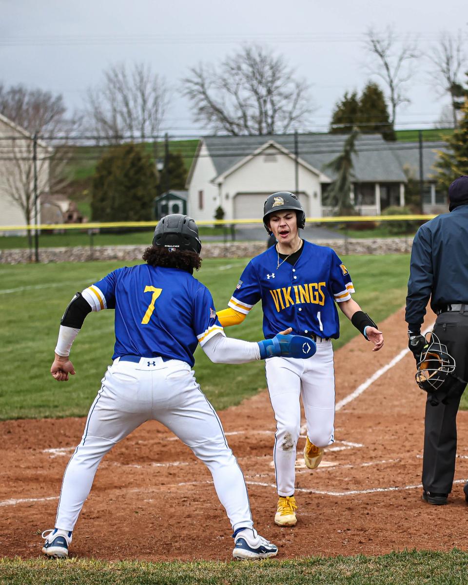 Moises Gonzalez (7) congratulates Adrian Gonzalez (1) as he scores from second base. The Northern Lebanon Vikings played host to the Lancaster Catholic Crusaders in a LL League Section 4 Baseball game on Friday April 5, 2024. The Vikings defeated the Crusaders 10-3.