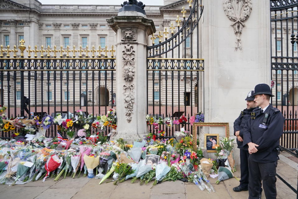 Flowers outside Buckingham Palace in London, following Thursday's death of Queen Elizabeth II, in London, Friday Sept. 9, 2022. (Dominic Lipinski/PA via AP)